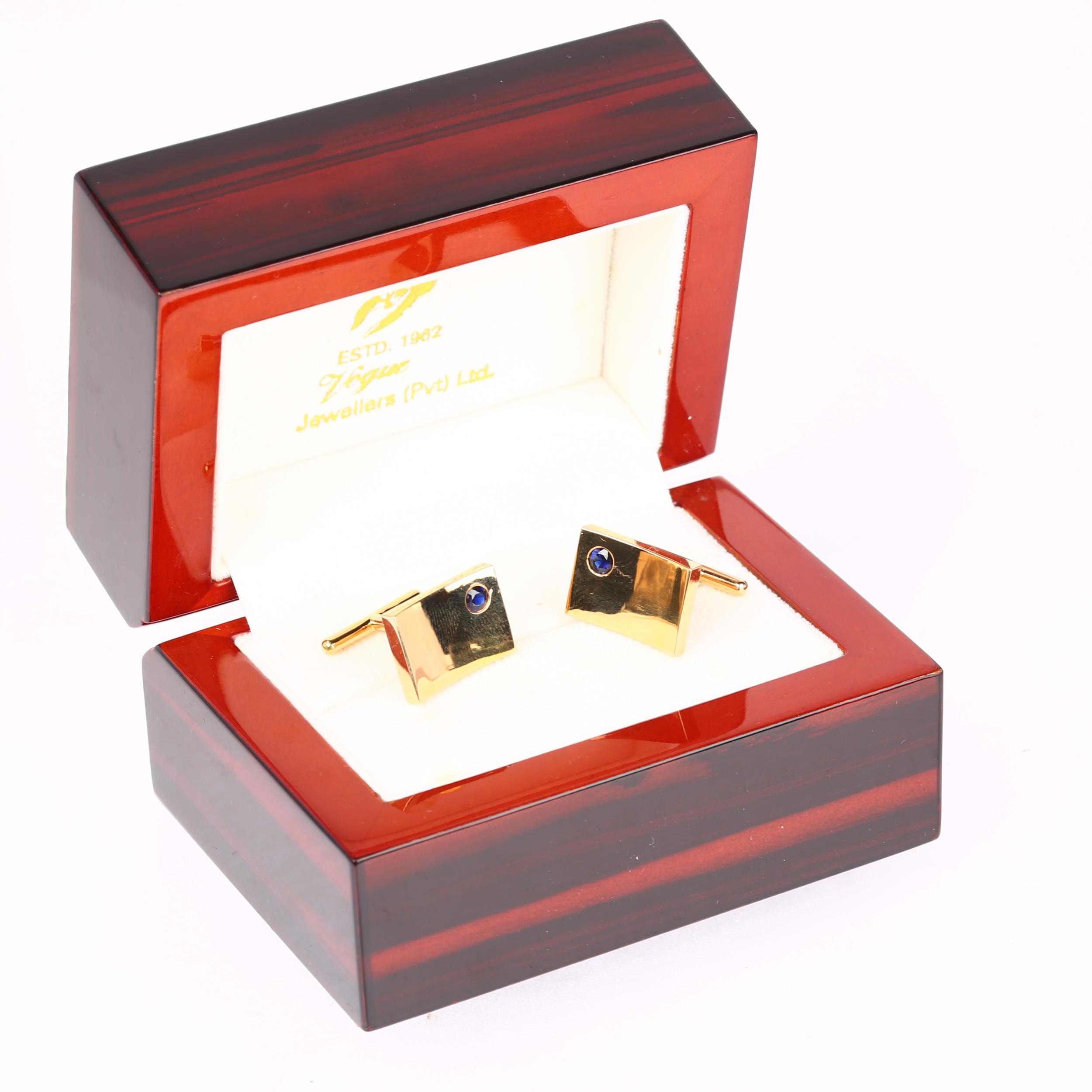 A pair of Ceylon sapphire cufflinks, by Vogue Jewellers Ltd, unmarked gold settings with rectangular - Image 4 of 4