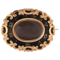 A Victorian black enamel "in memory of" mourning brooch, unmarked yellow metal closed-back