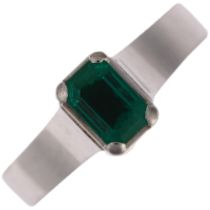An 18ct white gold solitaire emerald ring, maker BEV, palladium-topped, claw set with 0.5ct
