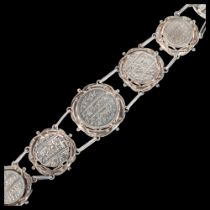 A large and heavy Indian silver graduated coin bracelet, composed of rupee coins from British Madras