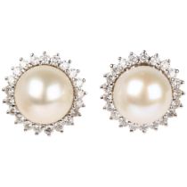 A pair of 18ct white gold whole pearl and diamond flowerhead cluster earrings, claw set with