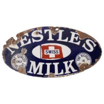 An Antique oval enamel advertising sign for Nestles Milk, diameter 54cm