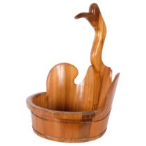 A large polished pine fruit bowl, surmounted by a duck, H65cm