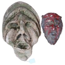A red painted plaster devil wall mask, and another (2)