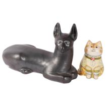 A metallic glazed resting Siamese type cat, signed, L40cm, and a De Bethel cat