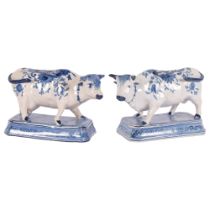 Delft blue and white pottery cow, length 20cm, base length 17cm, and another similar Delft cow