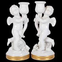 A pair of Vista Alegre cherub candlesticks, signed on base, 21cm