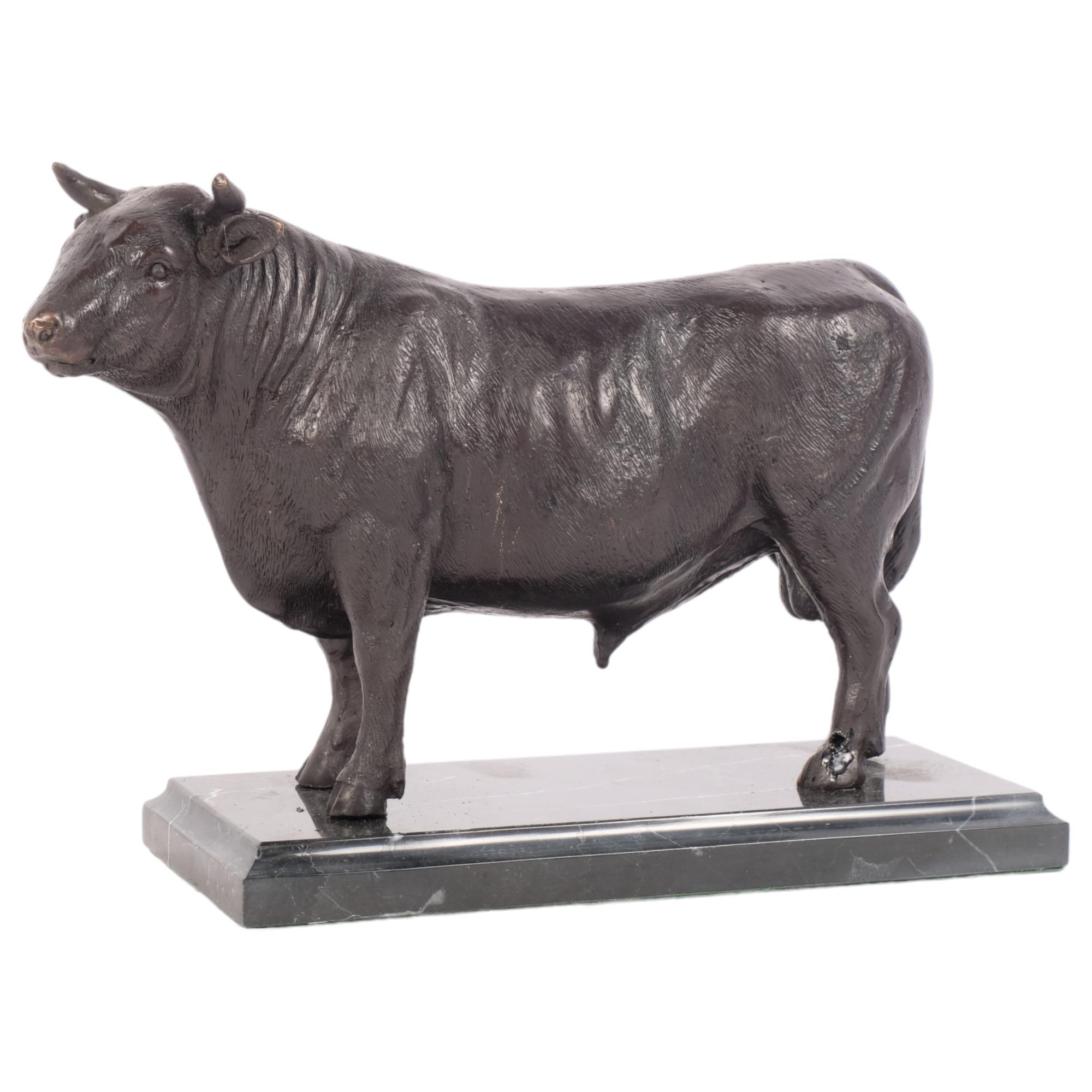 A bronze sculpture of a bull, on a marbled base, H17cm