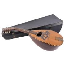 An 8-string bowl-back mandolin, in associated softshell casing, unmarked