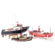 A hand-built wooden pond yacht on associated wooden display stand, L45cm, and a hand-built lightship