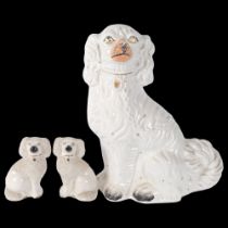 An Edwardian Staffordshire pottery mantel Spaniel, 32cm, and a pair of pottery Spaniels