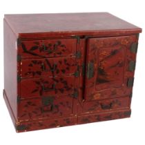 A Chinese red lacquered table top jewellery/travelling chest, with fitted drawers, painted