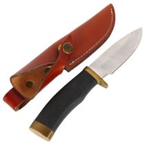 A "Buck" belt knife in leather sheath, overall length 24cm
