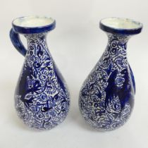 A pair of Vintage blue and white pottery jugs, with griffon decoration, H32cm