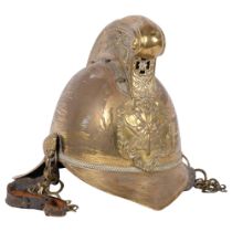 A brass fireman's helmet, with leather lining and original strap