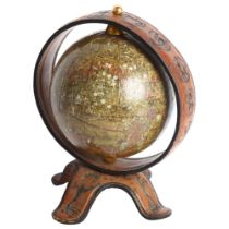 A Spanish table-top terrestrial globe, on tooled leather stand and mount, H23cm