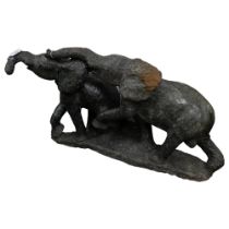 An African green serpentine marble carved sculpture of 2 elephants, length approx 83cm Good