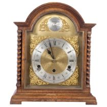 A 1920s oak-cased arch-top bracket clock, brass arch-top dial, silver chapter ring and Roman