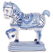 French faience blue and white pottery saddled horse, height 23.5cm, base length 18cm Good condition