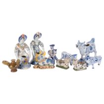 Delft blue and white pottery cow creamer, length 18cm, a pair of polychrome cows, a bird whistle,