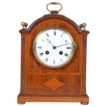 An Edwardian mahogany and satinwood-banded arch-top mantel clock, white enamel dial and Roman