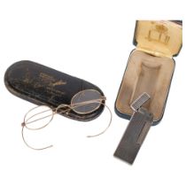 A Vintage Ronson lighter in original box, and a pair of unmarked gold? framed Vintage glasses, in