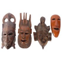 A group of 4 wooden Tribal design masks, likely decorative tourist pieces, largest length 42cm (4)