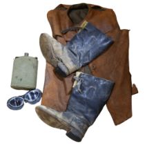 An early 20th century gent's leather sleeveless jacket, a pair of boots, A/F, motorcycle glasses,