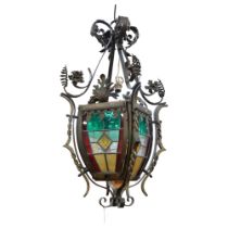 An impressive early 20th century wrought-iron ceiling lantern light fitting, with stained glass