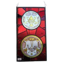 A rectangular coloured leadlight glass panel with 2 circular roundels, depicting a hunting horn,