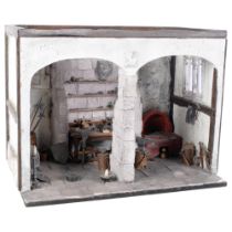 A painted plaster model of a blacksmith's forge on plinth, with various tools, shields, miniature