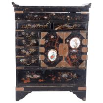 A Chinese Antique black lacquer chest, with rising lid and fitted compartment under, with engraved