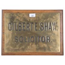 A Vintage brass Solicitors wall plaque for Gilbert E. Shaw Solicitor Commissioner For Oaths, mounted