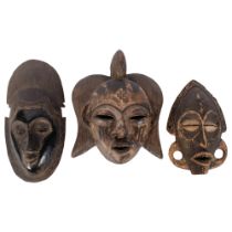 A carved wood mask with painted decoration, H36cm, and 2 other carved wood masks