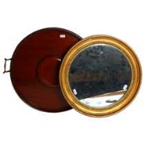 A circular gilt-framed wall mirror, diameter 40cm, and an Edwardian mahogany circular 2-handled