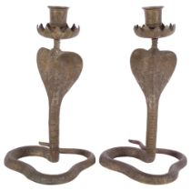 A pair of engraved brass cobra candlesticks, 27.5cm