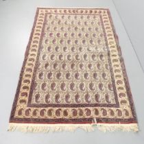 A cream-ground Persian rug. 220x130cm