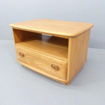 ERCOL - A Windsor model 1130 corner drop-leaf TV cabinet, with single drawer and maker's button.