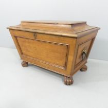 An antique style oak cellarette in the form of a sarcophagus tea caddy, lacking liner. 77x50x50cm.