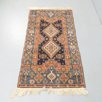 A red and blue-ground Herez rug. 155x85cm.