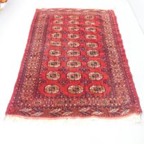 A red-ground Afghan carpet. 205x143cm