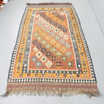 A red-ground Kilim rug. 246x128cm.