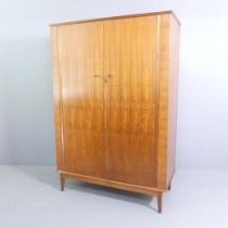 ALFRED COX - a mid-century teak and satin walnut two-door wardrobe, with rail fitted interior and