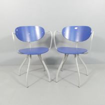 A pair of contemporary open arm desk chairs, with painted bend ply seats and backs on metal frame.