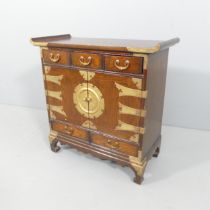 A Korean elm altar cabinet, with brass mounts, two cupboards and five drawers. 66x66x30cm.