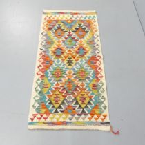 A Chobi Kilim runner. 140x66cm.