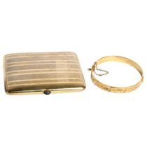 A gold plated cigarette case with a stone set button, and a gold plated engraved bangle