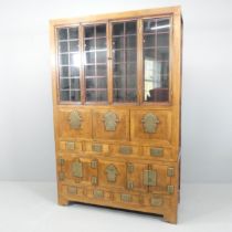 A Korean two-section cabinet, with two bi-fold doors, eight drawers, two fall-front doors and two