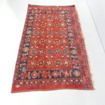 A red-ground Afghan rug. 178x102cm.