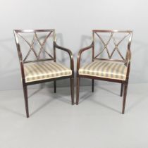 A pair of mid-century mahogany and brass line inlaid open arm or desk chairs.